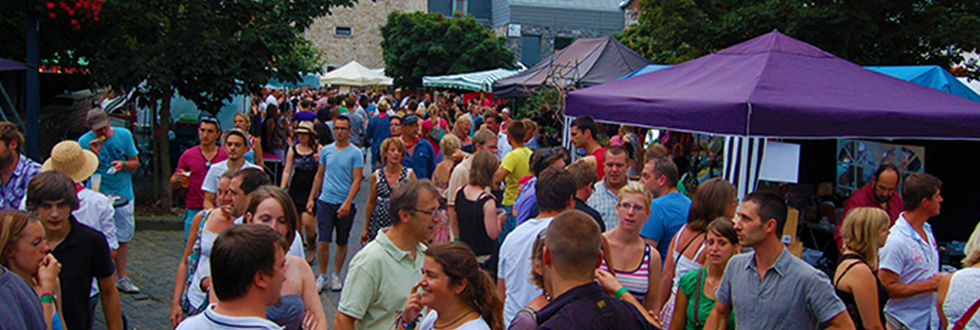 Menigte bezoekers tussen de tenten en standen van de markt